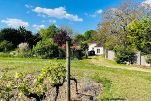 a garden with a pole in the middle of a field at Villa paisible avec piscine in Bercloux