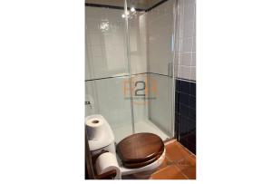 a bathroom with a toilet and a shower at 15A08 El Rosal By R2R in Buelna +8 photos