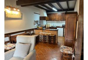 a kitchen with a couch and a table in a room at 15A08 El Rosal By R2R in Buelna