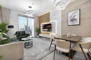 a living room with a table and chairs and a couch at Vida Dubai Mall! 2 Bedroom with Burj Khalifa View! Direct Access to Dubai Mall in Dubai