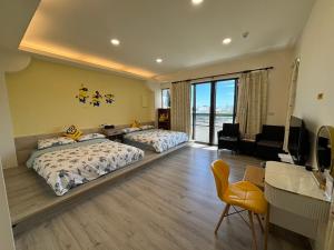 a bedroom with two beds and a desk and a television at Fu Lai Residence in Magong +28 photos