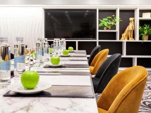 a conference room with a long table and chairs at Mercure Biel in Biel