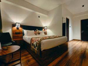 a hotel room with a bed and a chair at Mount Himalayan Hotel in Gangtok +37 photos