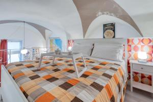 a bedroom with a bed with a table on it at Fore te capu casavacanze Lecce in Lecce