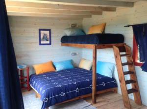 a bedroom with two bunk beds in a cabin at Bed0Bled Cabanes & Holiday homes in Sidi Kaouki +30 photos