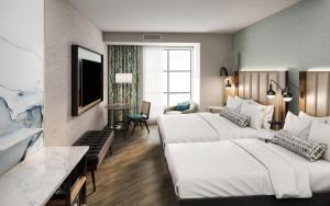 a hotel room with two beds and a television at Tempo By Hilton Savannah Historic District in Savannah