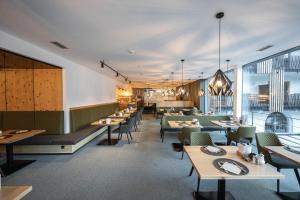 ブルグシオにあるMaraias - Luxury Suites & Apartmentsのテーブルと椅子と窓のあるダイニングルーム