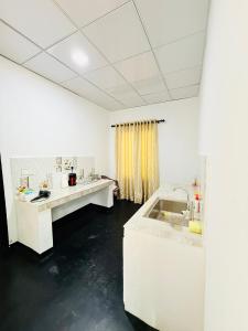 a white room with two sinks and a shower at Sigiri Bloom Villa in Sigiriya