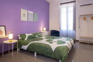 a bedroom with a green and white bed and a window at san Lorenzo by the sea in Augusta