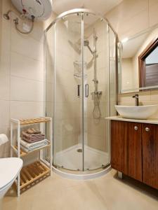 a bathroom with a shower and a sink at Valley View 1 in Luqa