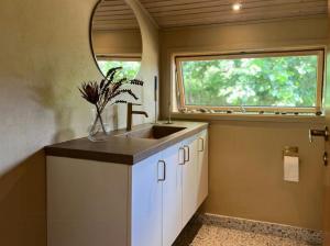 a kitchen with a sink and a window at Wonderful Family House At The West Coast in Løkken +24 photos