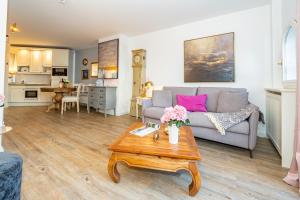 a living room with a couch and a table at Altstadttor 17 in Westerland +13 photos
