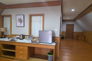 a kitchen with a counter with a refrigerator in a room at River Breeze Chiangsaen in Chiang Saen