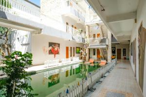 an external view of a house with a swimming pool at RedDoorz Plus @ Mahendradatta Denpasar in Denpasar