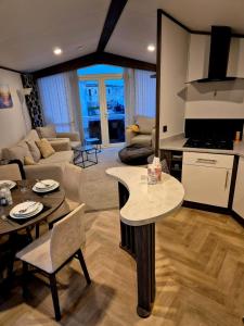 a kitchen and living room with a table and chairs at Sirrah Villa - Whitstable, Family & Pet friendly in Seasalter