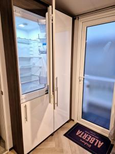 a refrigerator with its door open in a room at Sirrah Villa - Whitstable, Family & Pet friendly in Seasalter