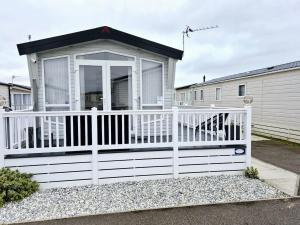 a small house with a white fence at Sirrah Villa - Whitstable, Family & Pet friendly in Seasalter