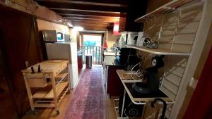 a small kitchen with a stove and a refrigerator at La Maison du Haut Plessix in Clayes