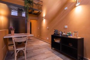a dining room with a table and a counter at Terre Saracene Suites - Elegance Near the Central Station in Bitonto