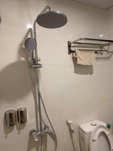 a shower in a bathroom with a toilet at LushStay Cao Bá Quát in Hanoi