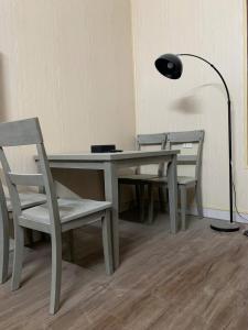 a table with two chairs and a lamp and a table with a lamp at LushStay Cao Bá Quát in Hanoi +6 photos