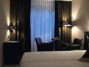 Postel nebo postele na pokoji v ubytování De Keyser Hotel