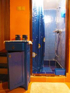 a bathroom with a shower with a blue shower curtain at Room Galina in Duga Resa +54 photos