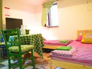 a living room with a bed and a table and chairs at Room Galina in Duga Resa
