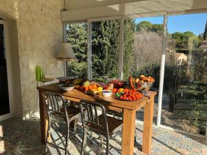 a table with bowls of fruits and vegetables on it at 3 Bedroom 2 Bath Villa Private Pool in Mougins in Mougins