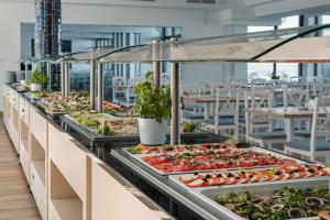 a buffet line with salads and vegetables on display at Apartamenty Rewita Bursztyn in Jurata