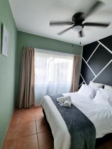 a bedroom with a bed with a ceiling fan at Home Away from Home 2 in Margate