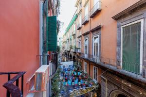 an alley with a bunch of blue vases on a balcony at Atri Rooms Centro Storico Napoli in Naples