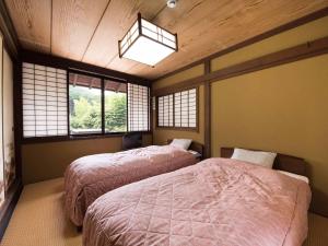 伊東市にある横浜藤よし伊豆店の窓が2つある部屋にベッドが2つある