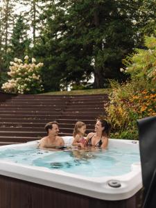 a group of people sitting in a bath tub at Chalet Alpin Walk to Lake and Beach with Spa and BBQ in Huberdeau