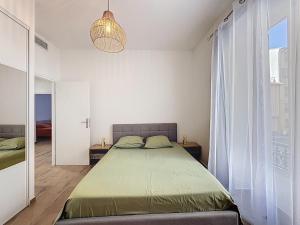 Ένα ή περισσότερα κρεβάτια σε δωμάτιο στο Le Francis - Riquier Port de Nice