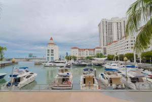 a group of boats in a marina in a city at Marina Chic l Stylish 2BR Retreat l Straits Quay in Tanjung Bungah