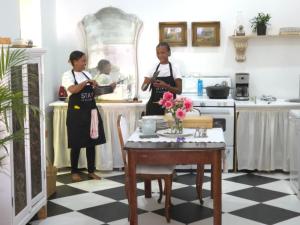 a couple of women standing in a kitchen at Stay at Richmond in Richmond