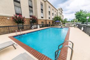 a swimming pool at a hotel with a building at Hampton Inn Jasper, AL in Jasper