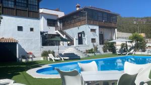 a house with a swimming pool in front of a house at Ziggy's Mountain Retreat in Vilaflor