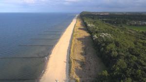 an aerial view of an island in the water at Ostseepark in Zempin