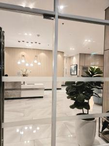 a lobby with a potted plant in a room at Casa Istilo Studio at Avida Abreeza Davao in Davao City