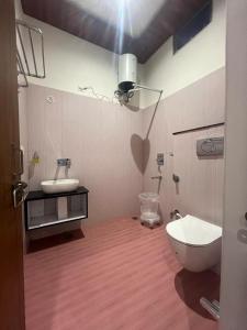 a bathroom with a toilet and a sink at Vedas Suites- Saryu Ghat Ayodhya in Ayodhya
