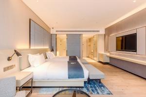 TV a/nebo společenská místnost v ubytování Echarm Hotel Nanning Wuxiang Headquarters Base