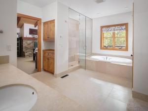 a bathroom with a tub and a sink and a shower at RMR: Granite Ridge Lodge 3217 in Teton Village in Teton Village +25 photos