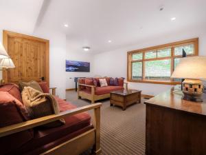 a living room with a couch and a table at RMR: Granite Ridge Lodge 3217 in Teton Village in Teton Village