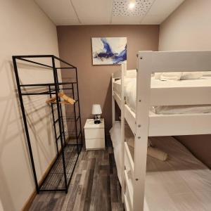 a room with three bunk beds and a lamp at Ziggy's Mountain Retreat in Vilaflor