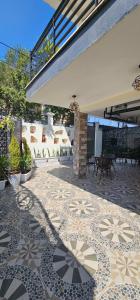 a patio with a tiled floor in front of a building at Calm Corner Addis in Addis Ababa