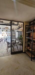 a dining room with a table and a view of a patio at Calm Corner Addis in Addis Ababa