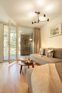 a living room with a couch and a table at RIVER Apartment in Andermatt