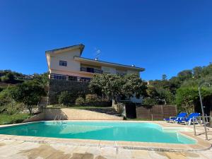 a house with a swimming pool in front of a house at Sonho No Mondego in Penacova
